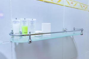 a glass shelf on the wall in a bathroom at Marrkson Suites Hotel in Nairobi