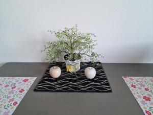 a table with a vase with a plant in it at New Center City Home in Kuopio