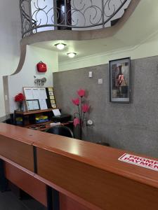 an office with a reception desk and a flower at TR CASA DE AcCOMODAÇÃO in Matola +75 photos