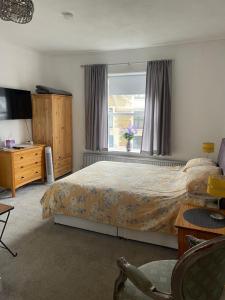 a bedroom with a bed and a window at Crispin House in Hunstanton