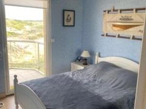a blue bedroom with a bed and a balcony at Appartement en bord de mer pour 4 pers avec balcon, parking et animaux admis - FR-1-236-169 in Cucq