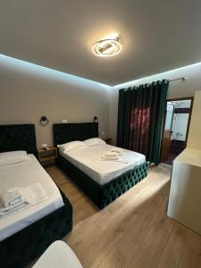 Postel nebo postele na pokoji v ubytování Guesthouse Dauti