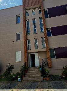 a building with a staircase leading to a door at Bindi Studio Apartment in Draç