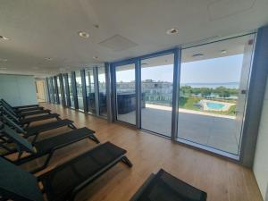 an empty gym with chairs and a large window at SzemesBay Apartment in Balatonszemes