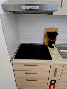 a kitchen counter with a sink in it at Bindi Studio Apartment in Draç