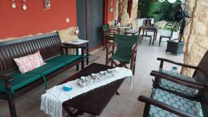 a patio with benches and a table and chairs at Villa Mariellie in Nea Peramos