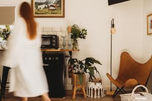 una donna che cammina in cucina con una pianta di Glenoak Cottage a Sparkes Creek