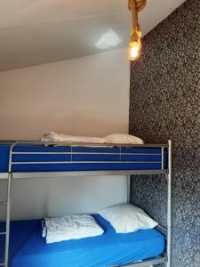 a bunk bed with two pillows on top of it at Cosy Petten, Family only in Petten +25 photos