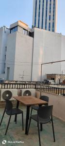 a wooden table and chairs on top of a building at Lovely Paceville Studio D in St. Julianʼs