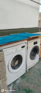 a washer and dryer with a counter on top of it at Lovely Paceville Studio D in St. Julianʼs