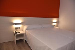 Postel nebo postele na pokoji v ubytování Hotel Julimar