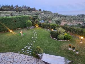 an aerial view of a garden with a person standing in the grass at Villa Mariellie in Nea Peramos