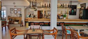 a restaurant with tables and chairs and a bar at Hotel Boutique Las Arenas in Es Cana +84 photos