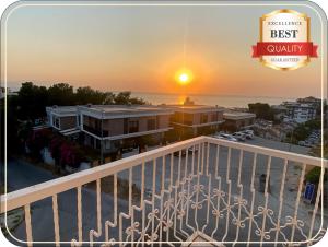 a view of the sunset from the balcony of a condo at Silver Tower Family Apart Otel in Kuşadası