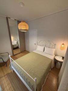 a bedroom with a bed and a bathroom with a mirror at Casa Di Sabbia Air-bnb in Nafpaktos
