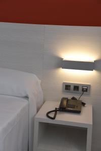 Postel nebo postele na pokoji v ubytování Hotel Julimar