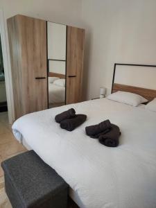 zwei Handtücher auf einem Bett mit einem Spiegel in der Unterkunft petite maison lavardac in Lavardac