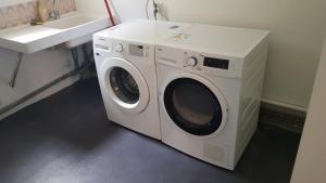 a washing machine sitting in a bathroom next to a sink at Maison ouvrière pour 10 personnes in Trignac