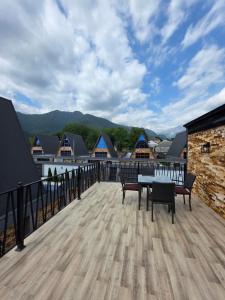 a balcony with a table and chairs on a roof at SOLAR Hotel and Restaurant in Gabala