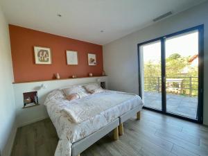 a bedroom with a bed and a large window at Maison individuelle contemporaine avec piscine in Urrugne +58 photos