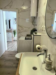 a white bathroom with a sink and a mirror at Apartment Bepo in Pakoštane +19 photos