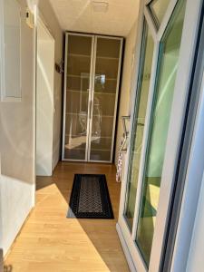 a hallway with a door and a mat on the floor at Heimatliebe in Neunkirchen +8 photos