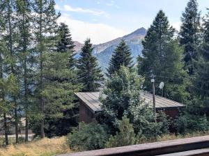 a house in the middle of a forest of trees at Charmant T2 5 pers, Sud, balcon, TV, lave-linge, garage optionnel, calme à Orcières - FR-1-262-187 in Orcières