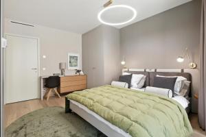 a bedroom with a large bed and a desk at Castle-side Luxury Residence on Danube River bank,Free Parking in Bratislava