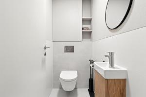 a bathroom with a toilet and a sink and a mirror at Castle-side Luxury Residence on Danube River bank,Free Parking in Bratislava +50 photos