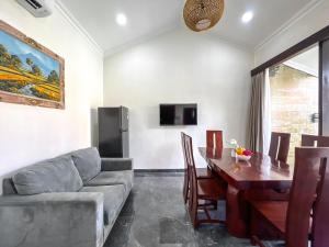 a living room with a couch and a dining room table at Villa Araya in Nusa Dua