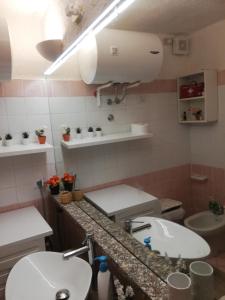 ein Badezimmer mit zwei Waschbecken und einer Toilette in der Unterkunft Lucianasit in Cugnana Verde + 39 Fotos