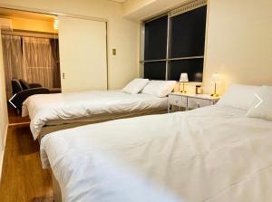 Postel nebo postele na pokoji v ubytování r311 なんば 道頓堀エリアの宿 最大8名 2LDK