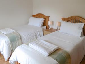 two beds sitting next to each other in a room at Rockhill in Inverness