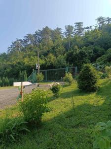 a park with a bench in the grass at Sobe pri Roži in Postojna