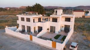 an aerial view of a large white house at Mediterranean Blue Suites & Villa - Blue Bay Suite in Tympáki