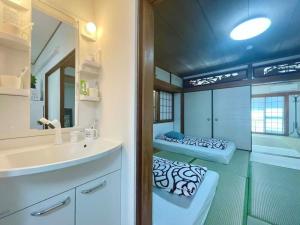 a bathroom with a sink and a mirror at Nippori Osaka Nishi-Tengachaya Guesthouse西天下茶屋アパートメント in Osaka +37 photos