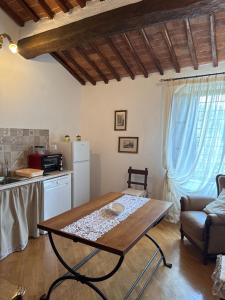 a living room with a table and a kitchen at Casa Crevole in Palazzina