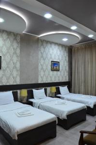 Ένα ή περισσότερα κρεβάτια σε δωμάτιο στο Pearl Tashkent