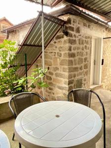 a white table and chairs on a patio at Apartments Bella in Kotor