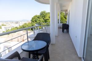 a balcony with a table and chairs on a balcony at LuxuryHomeUlcinj2 in Ulcinj