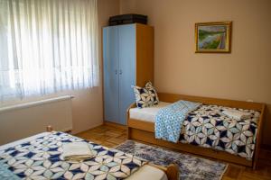 a bedroom with two beds and a cabinet at Apartment Stella in Bihać