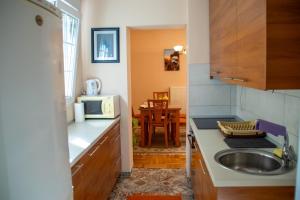 a kitchen with a sink and a microwave at Apartment Stella in Bihać +10 photos