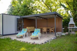 a wooden deck with a gazebo with a table and chairs at Apartment Stella in Bihać