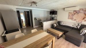 a living room with a couch and a table at L’appartement du Micocoulier in Salon-de-Provence