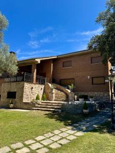 a large brick building with stairs and a building at Quinta El Escorial in Escorial