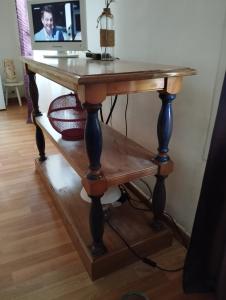 an old wooden table with a shelf underneath it at Appartement d'Artiste in Cotignac