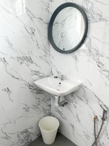 a bathroom with a sink and a mirror on the wall at NAR Kampung Studio in Bayan Lepas +2 photos