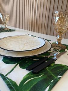 a table with a plate and a fork and knife at Otima localizacao metro Sacoma Aeroporto Congonhas Av Paulista Great location 80m subway near Av Paulista and Congonhas Airport Smart TV 50 free channels 600gb WiFi Pool Gym in Sao Paulo