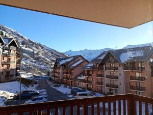 a balcony with a view of a snowy mountain at valmeinier 1800 appartement in Valmeinier