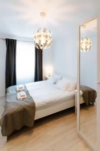 a bedroom with a bed and a mirror at Kis-Duna Lak in Esztergom